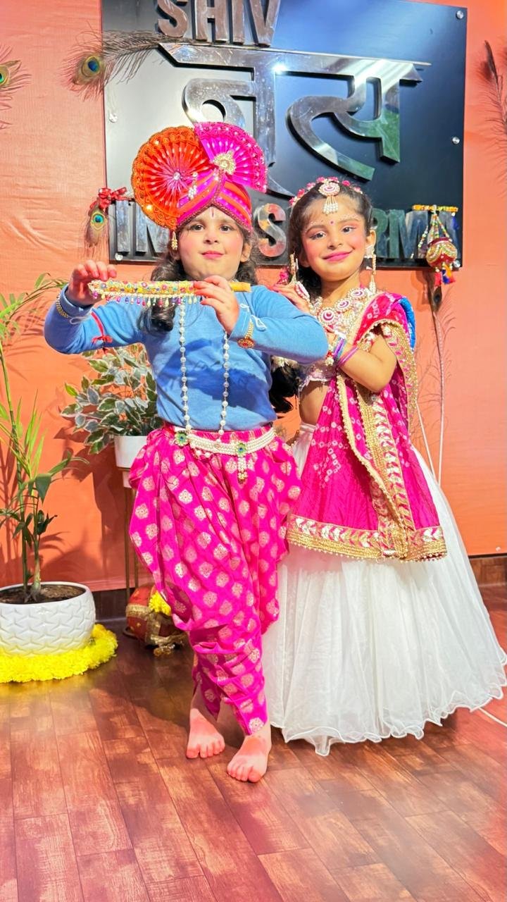 Two students dressed as Radha and Krishna for a themed performance